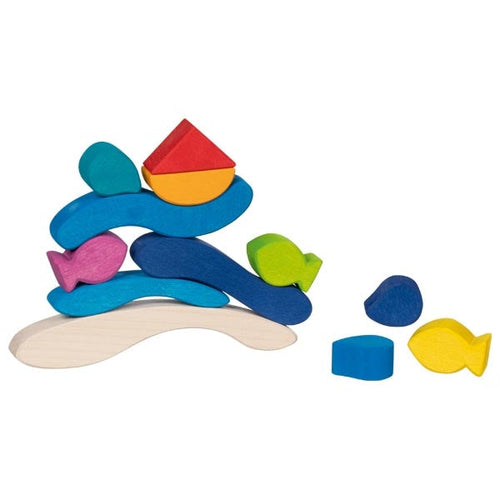 Colorful wooden toy with fish and underwater landscape on a white background