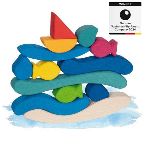 Colorful wooden toy stack with fish and sailboat shapes on a white background, featuring a sustainability award badge.