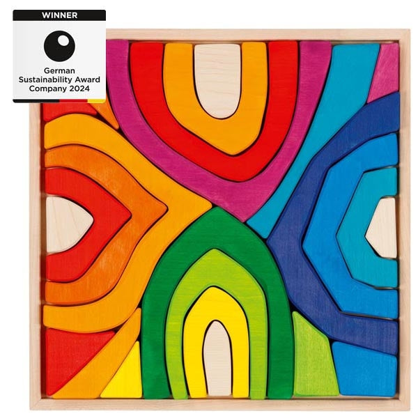Colourful wooden puzzle with abstract design and award text on a white background