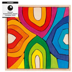 Colourful wooden puzzle with abstract design and award text on a white background