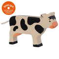 Wooden cow toy with black spots and orange nose, branded 'spiel gut' on a white background