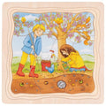Children's illustration of two children playing with a chicken under a tree with birds.