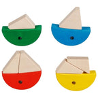 Four colorful wooden sailboats on a white background