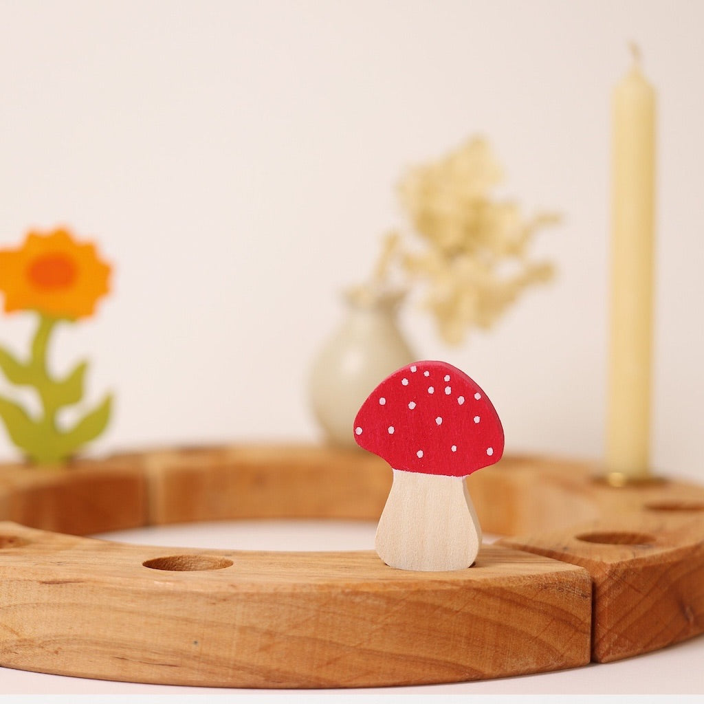 Wooden mushroom decoration on a wooden stand with a blurred background