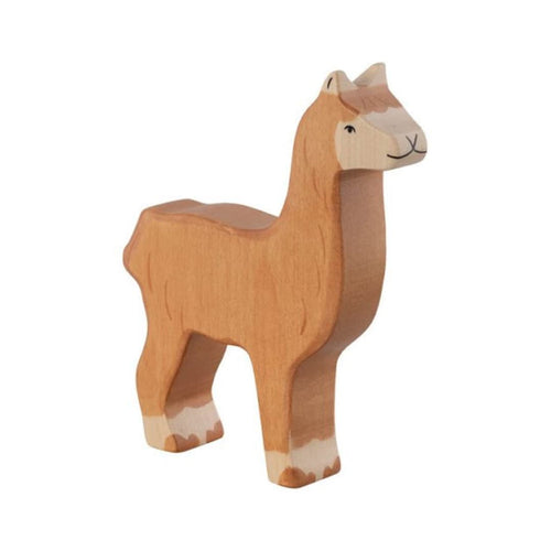 Wooden alpaca figure on a beige background
