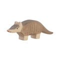 Wooden armadillo toy on a beige background