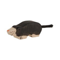 Wooden toy mole with a black body and beige feet on a white background