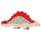 Toy dinosaur with red spikes on a white background
